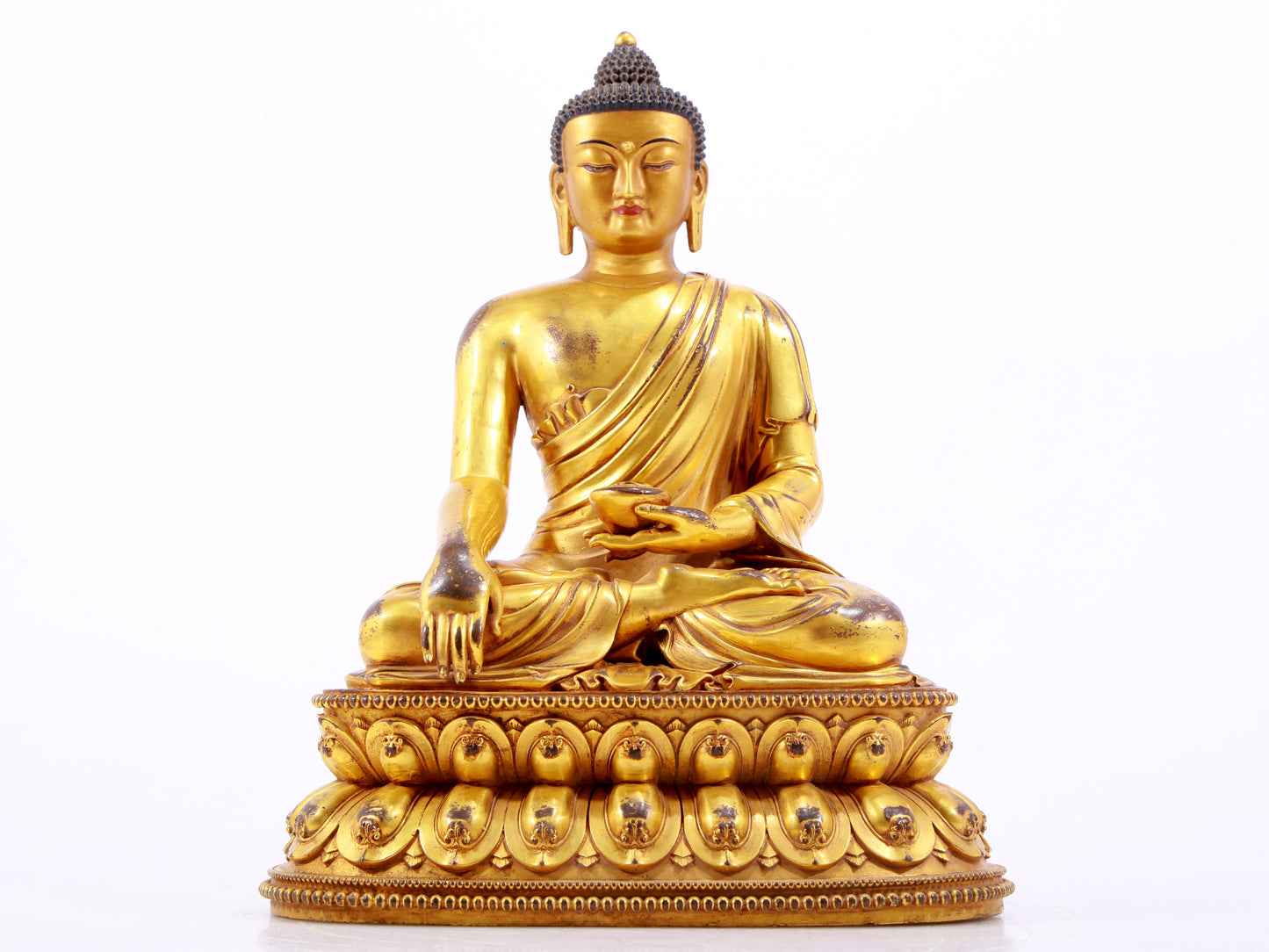 A majestic gilt bronze statue of Sakyamuni