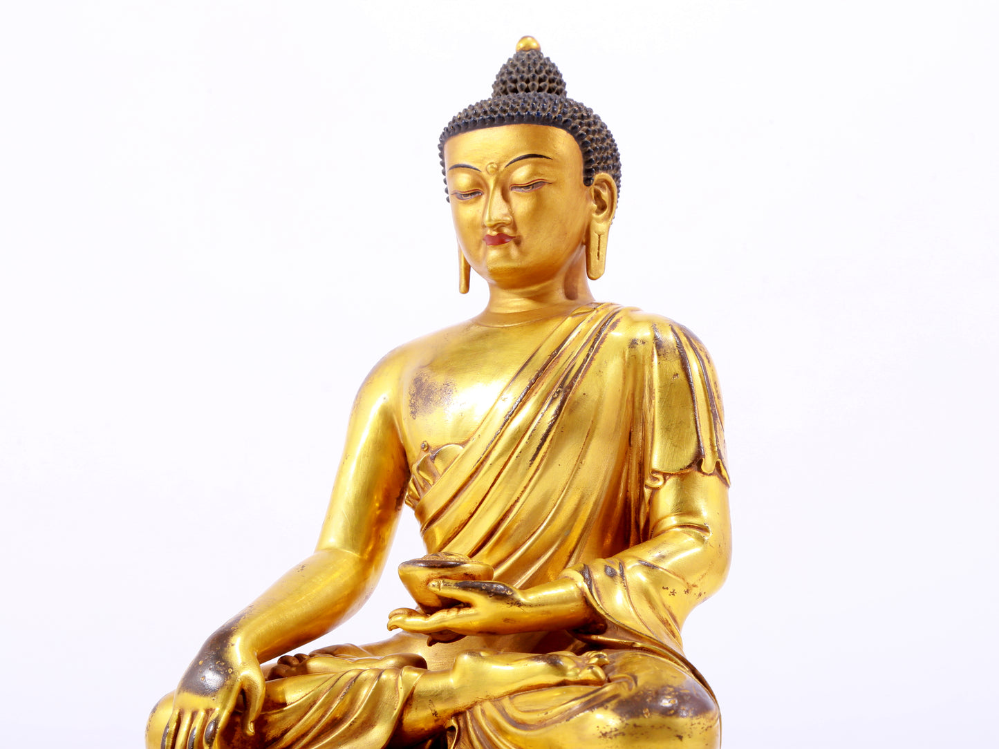 A majestic gilt bronze statue of Sakyamuni