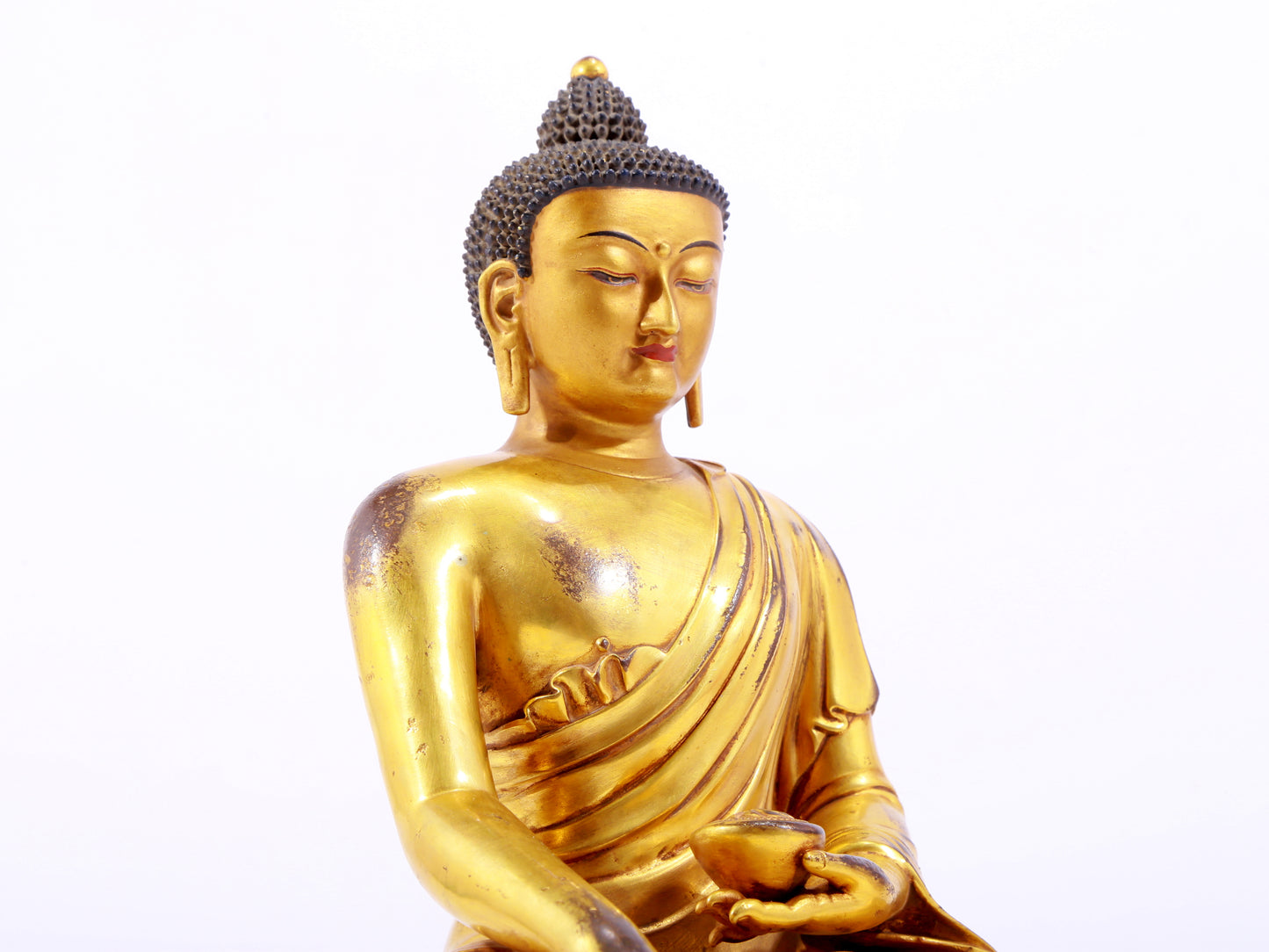 A majestic gilt bronze statue of Sakyamuni