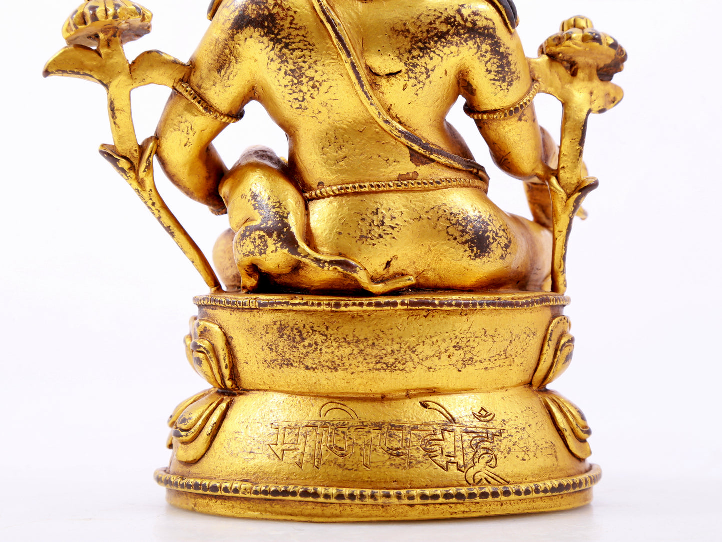 A solemn gilt bronze statue of the God of Wealth