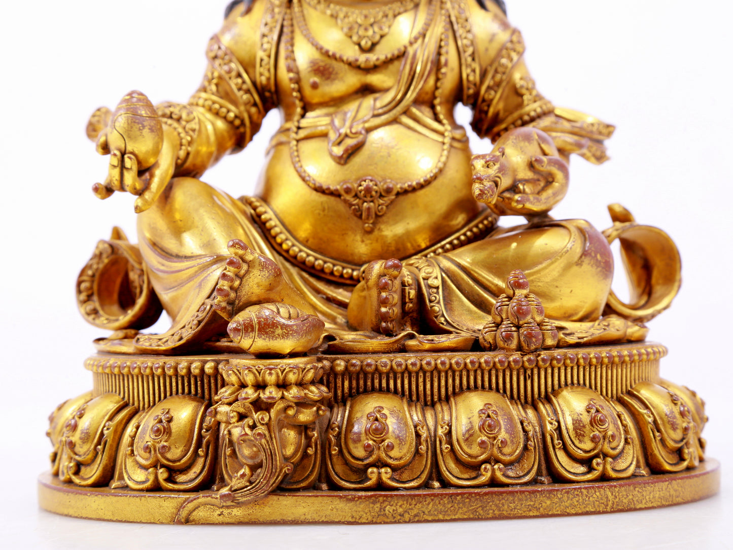 A solemn gilt bronze statue of the God of Wealth