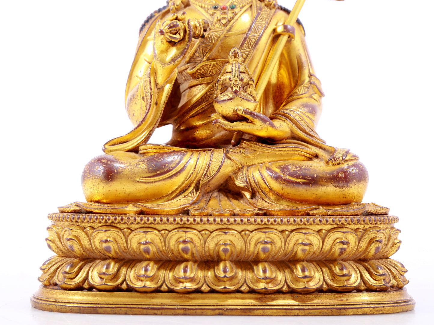 A solemn gilt bronze statue of Padmasambhava