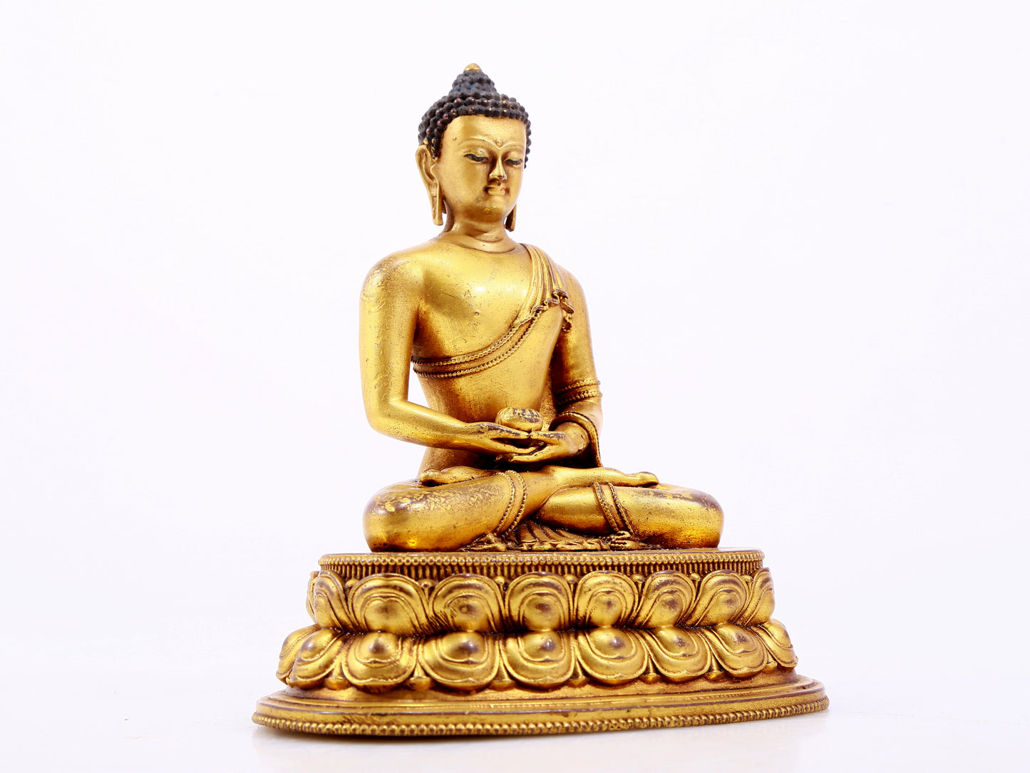 A majestic gilt bronze statue of Sakyamuni