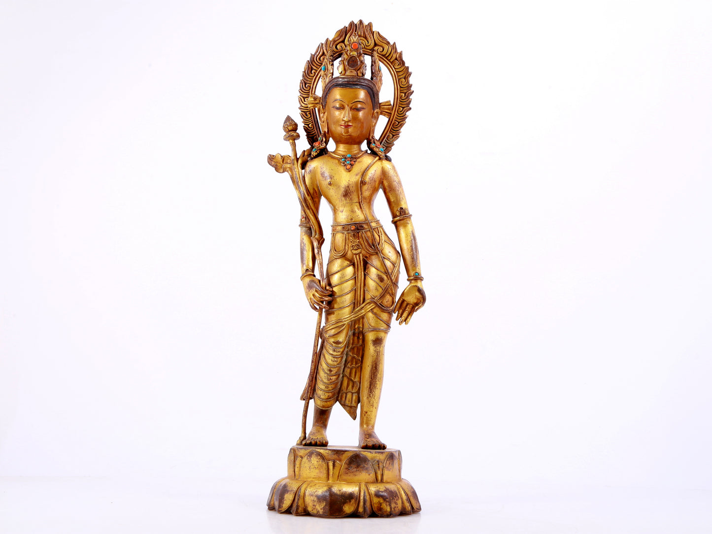 A solemn gilt bronze statue of Tara inlaid with hundreds of treasures