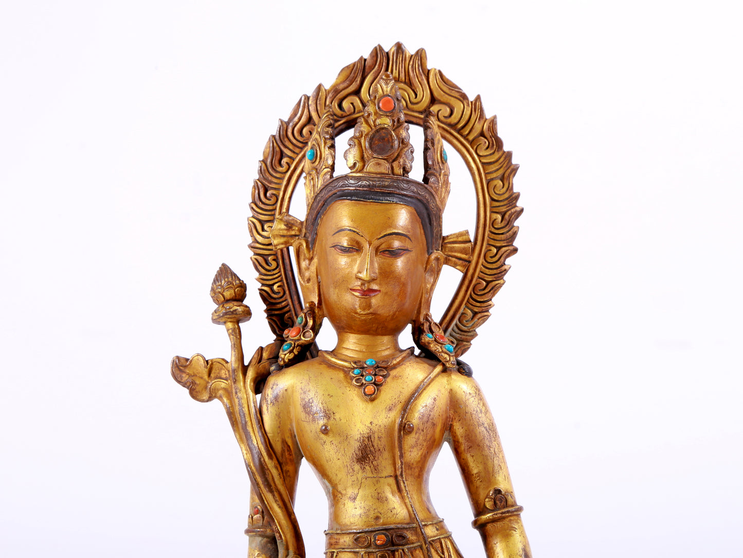 A solemn gilt bronze statue of Tara inlaid with hundreds of treasures