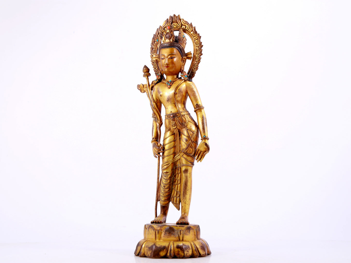 A solemn gilt bronze statue of Tara inlaid with hundreds of treasures