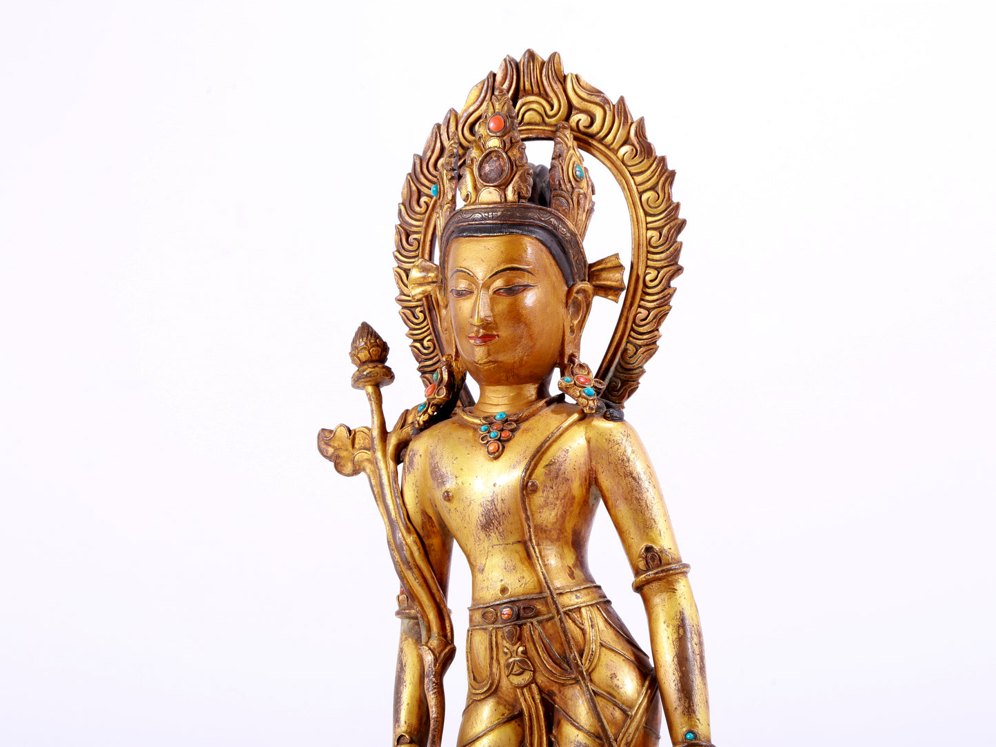 A solemn gilt bronze statue of Tara inlaid with hundreds of treasures