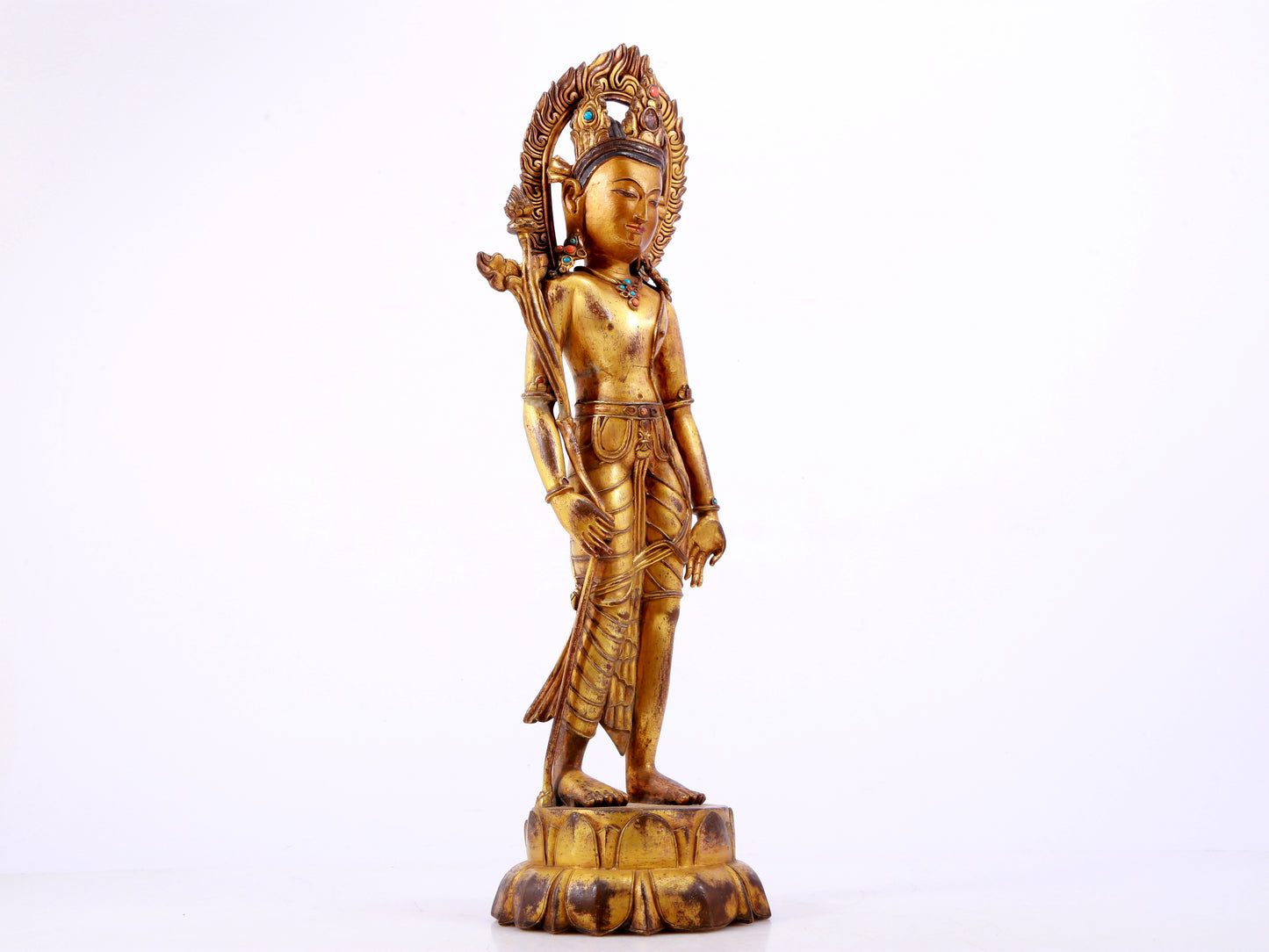 A solemn gilt bronze statue of Tara inlaid with hundreds of treasures