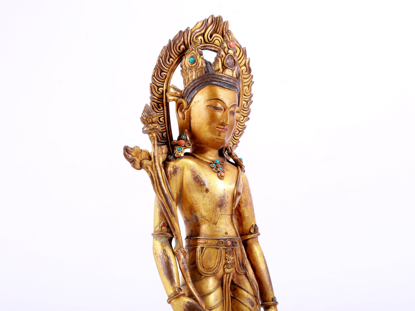 A solemn gilt bronze statue of Tara inlaid with hundreds of treasures