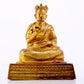 A solemn gilt bronze statue of the Guru