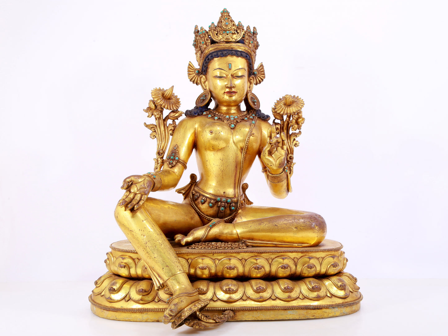 A solemn gilt copper inlaid turquoise green Tara statue