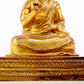 A solemn gilt bronze statue of the Guru