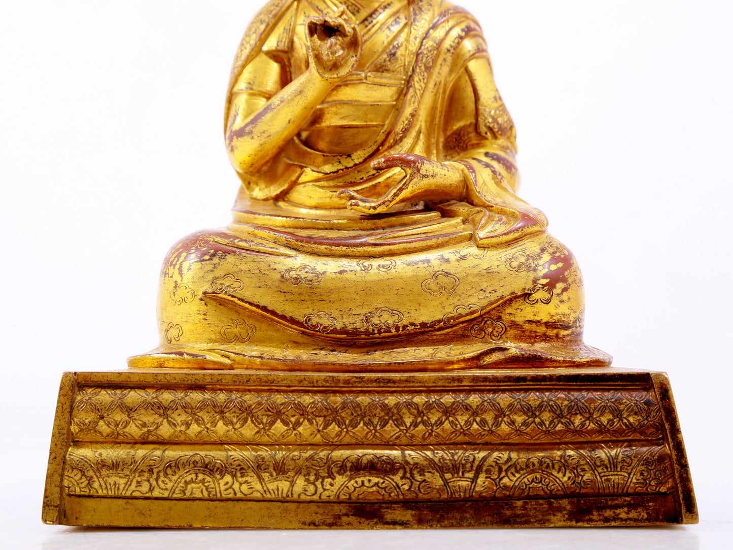 A solemn gilt bronze statue of the Guru