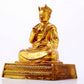 A solemn gilt bronze statue of the Guru