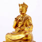 A solemn gilt bronze statue of the Guru