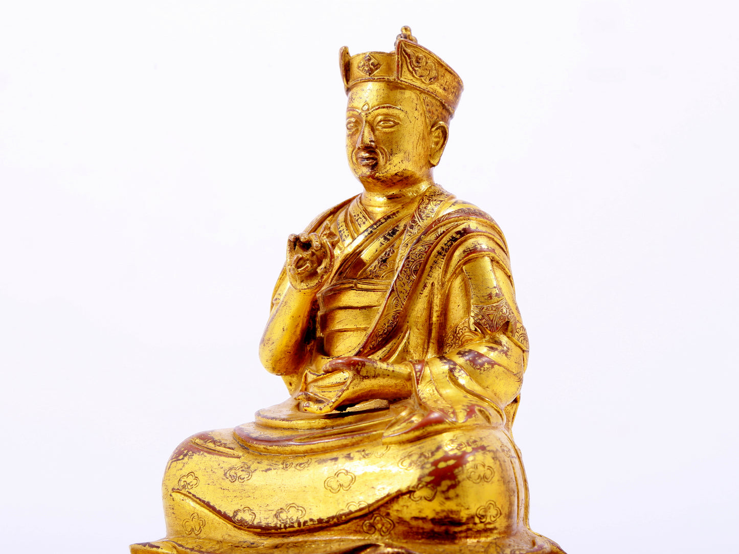 A solemn gilt bronze statue of the Guru