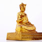 A solemn gilt bronze statue of the Guru