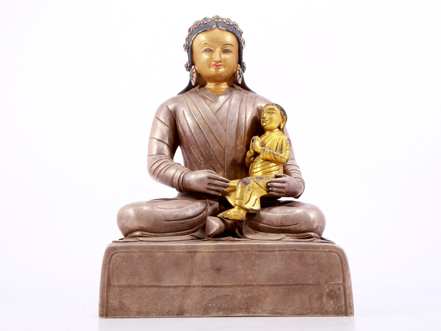 A solemn gilt bronze and silver figure inlaid with hundreds of treasures