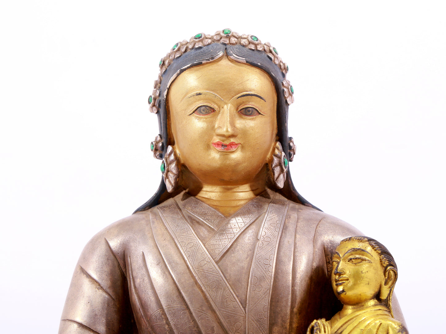 A solemn gilt bronze and silver figure inlaid with hundreds of treasures