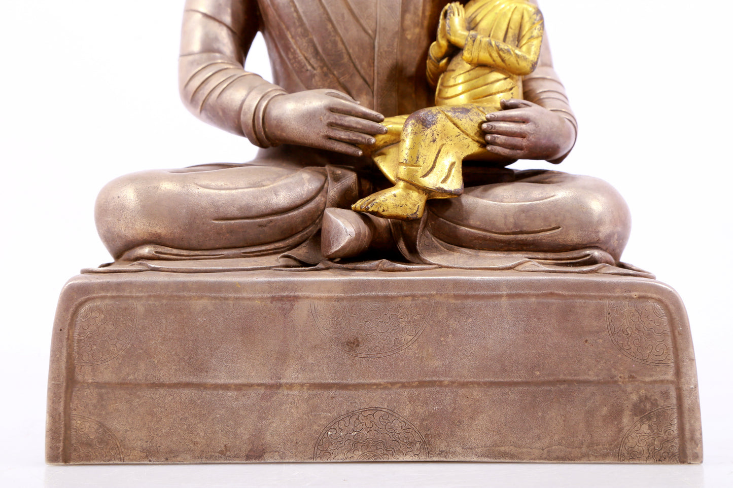 A solemn gilt bronze and silver figure inlaid with hundreds of treasures