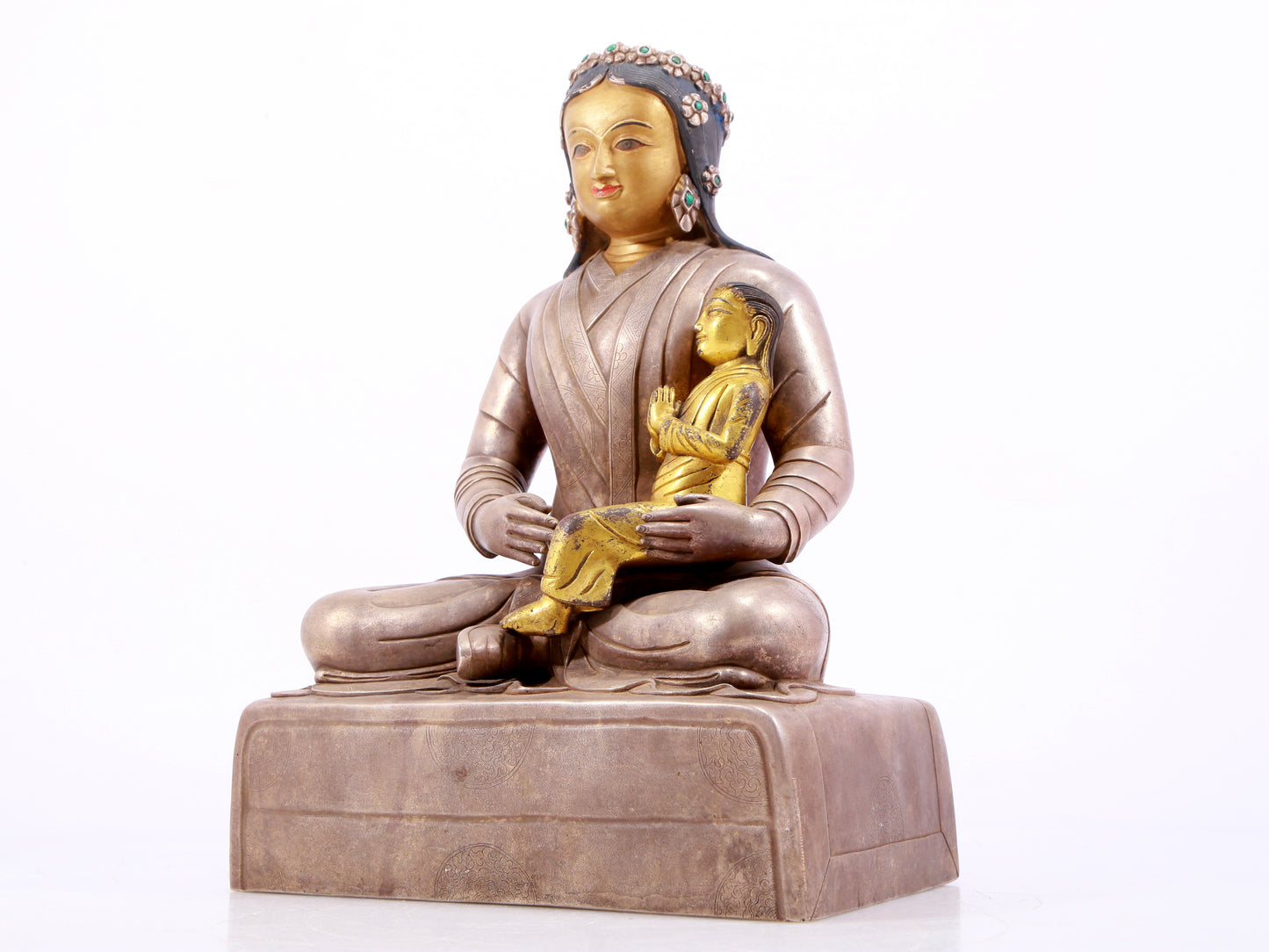 A solemn gilt bronze and silver figure inlaid with hundreds of treasures