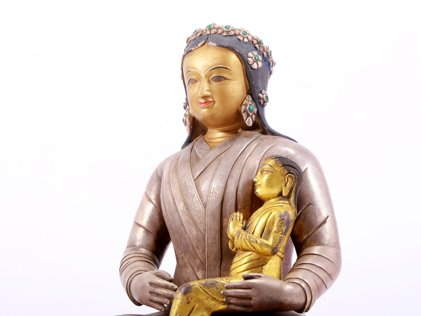 A solemn gilt bronze and silver figure inlaid with hundreds of treasures