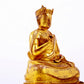 A solemn gilt bronze statue of the Guru