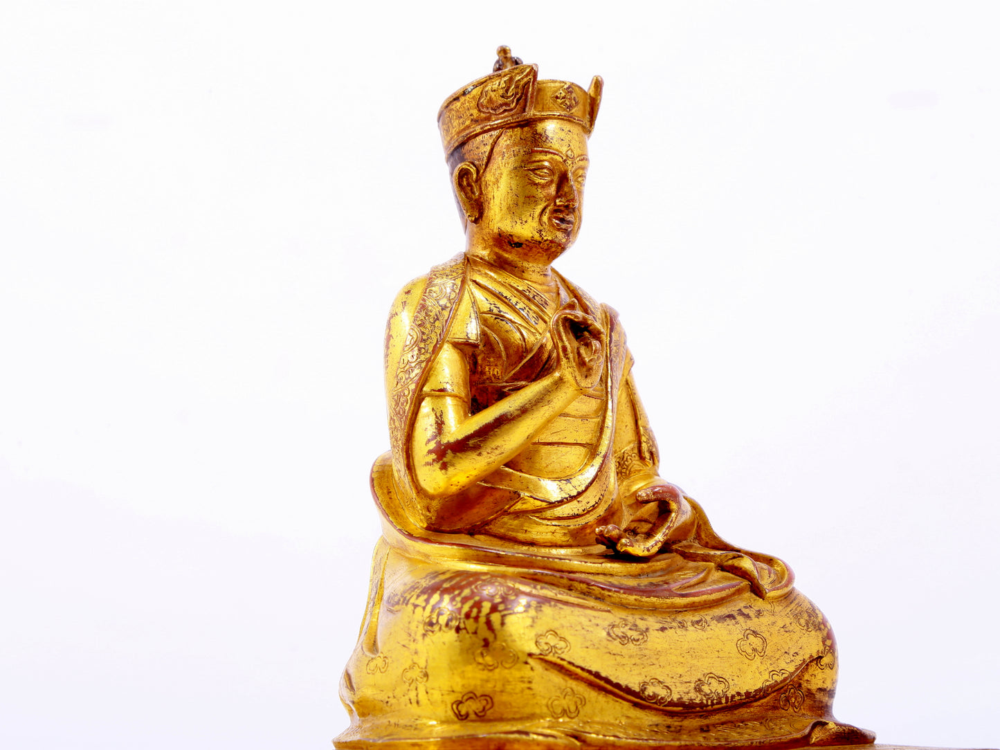 A solemn gilt bronze statue of the Guru