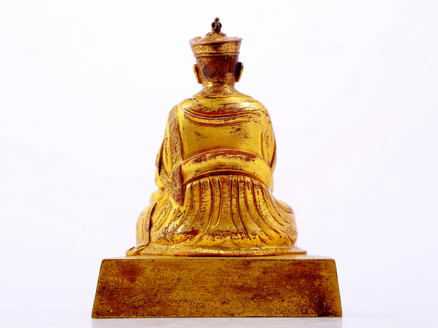 A solemn gilt bronze statue of the Guru