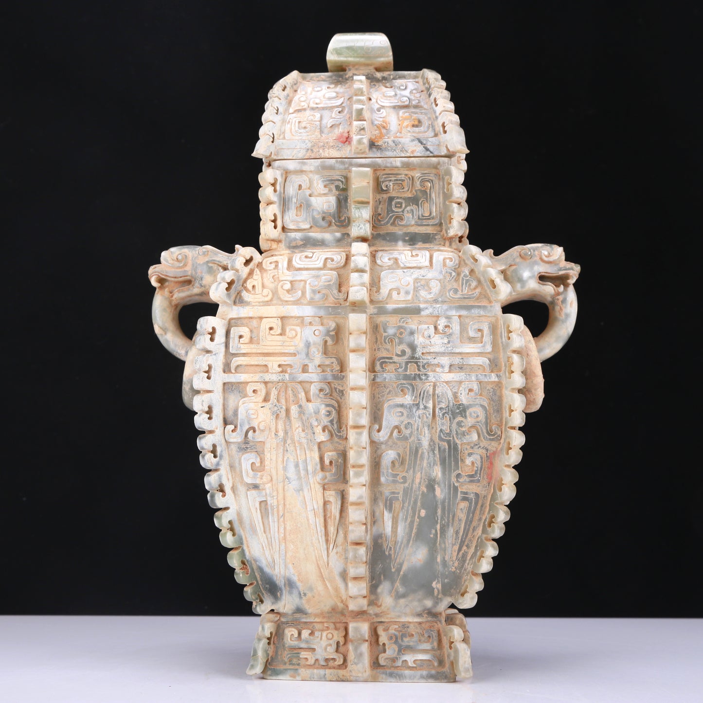 An Archaic Celadon-White Jade 'Auspicious Beast' Vase And Cover