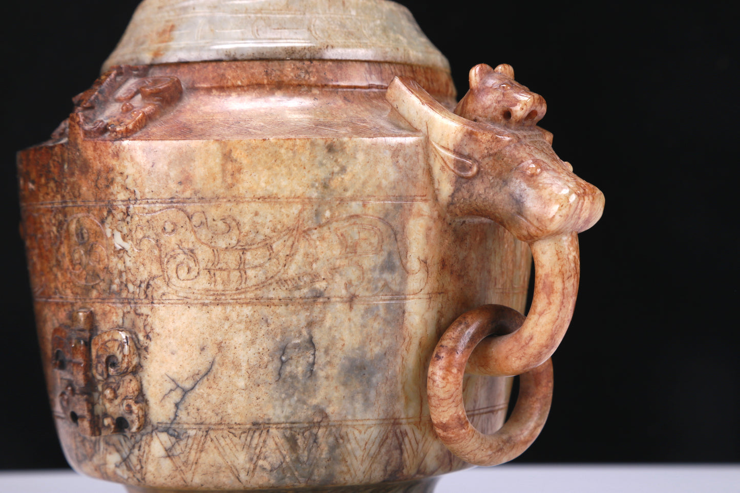 An Archaic White Jade 'Auspicious Beast' Jar And Cover