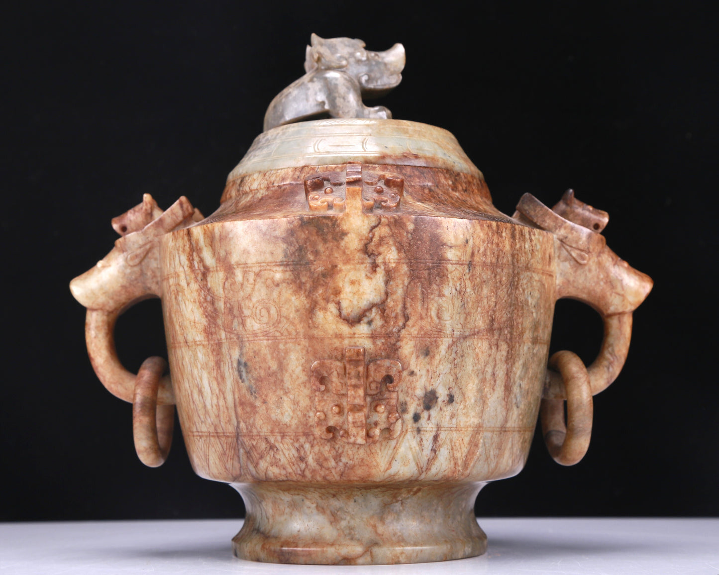 An Archaic White Jade 'Auspicious Beast' Jar And Cover