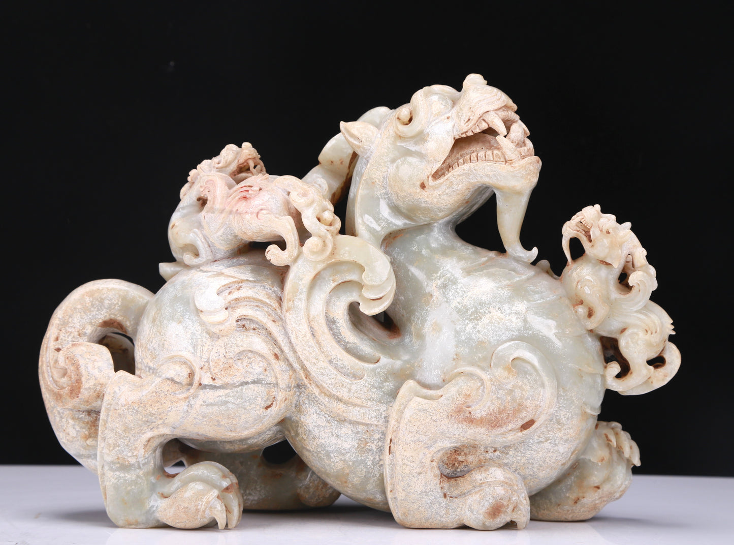 An Elaborate White Jade Dragon Group