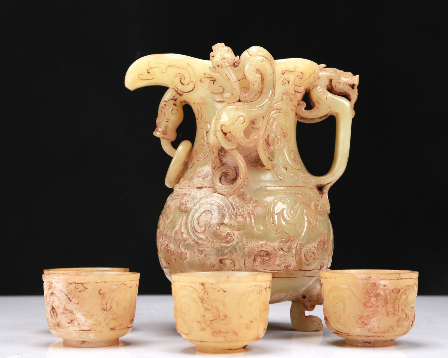 An Elaborate Yellow Jade 'Chi-Dragon' Tripod Ewer With Four 'Chi-Dragon' Cups