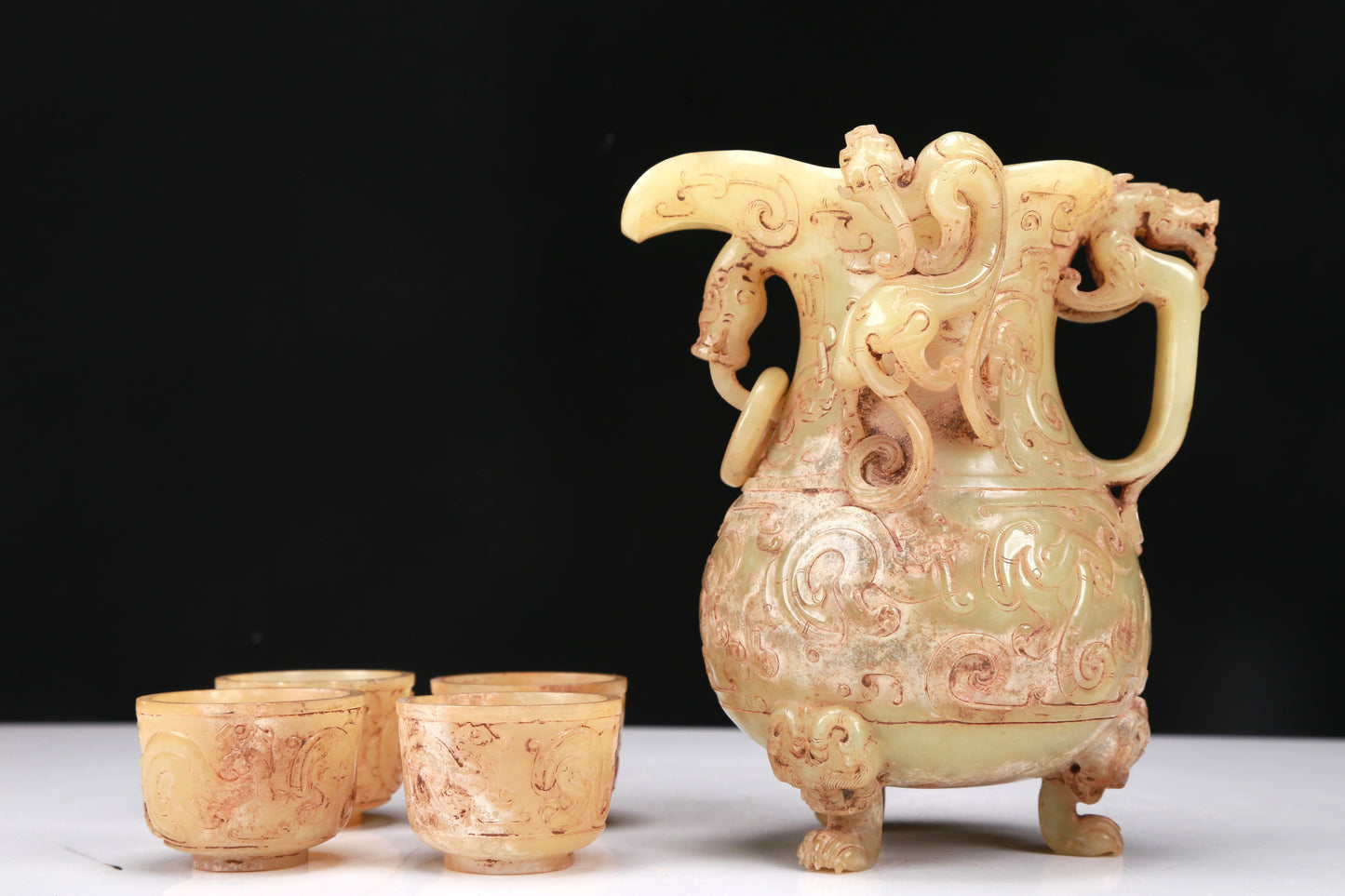 An Elaborate Yellow Jade 'Chi-Dragon' Tripod Ewer With Four 'Chi-Dragon' Cups