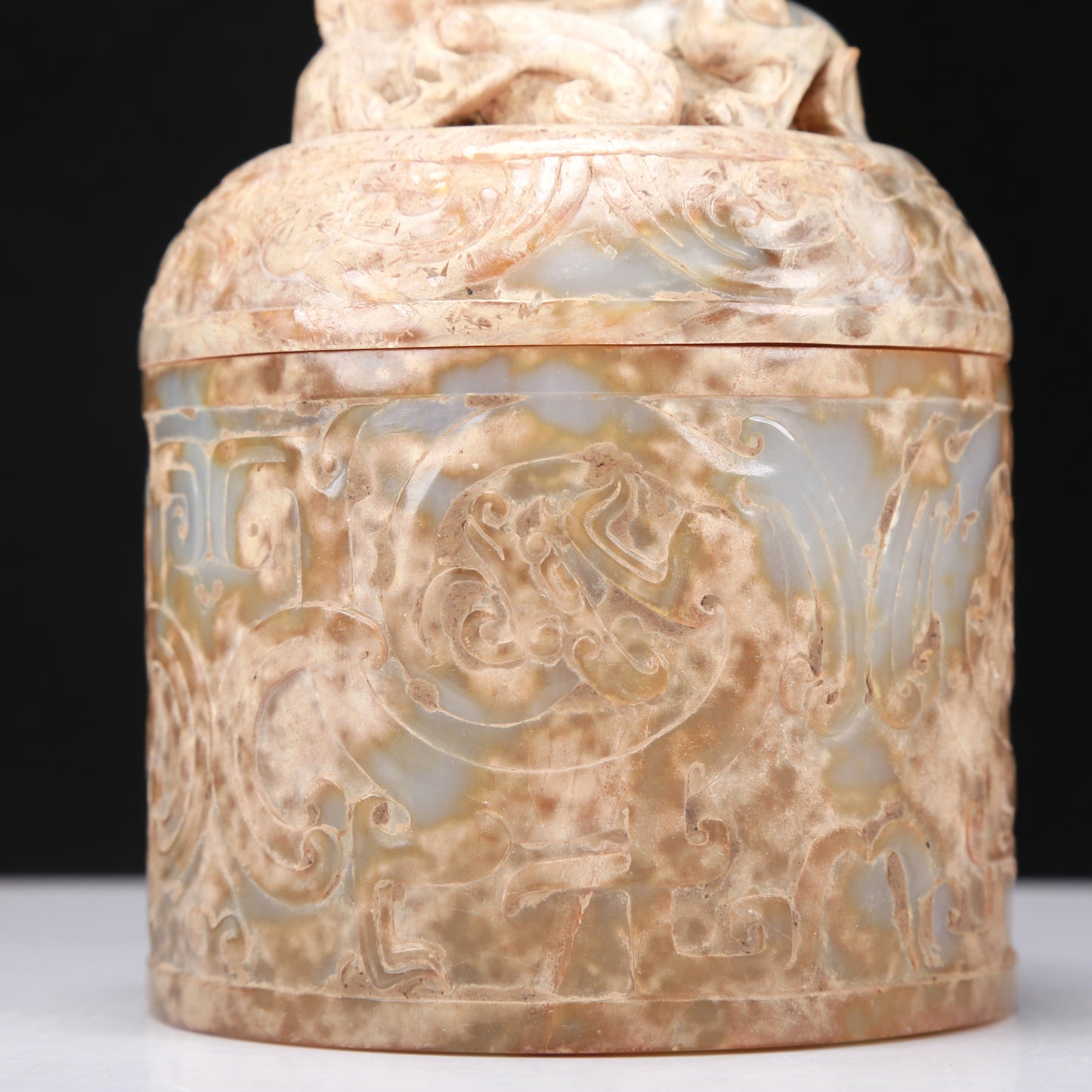 An Archaic White Jade 'Auspicious Beast' Jar And Cover