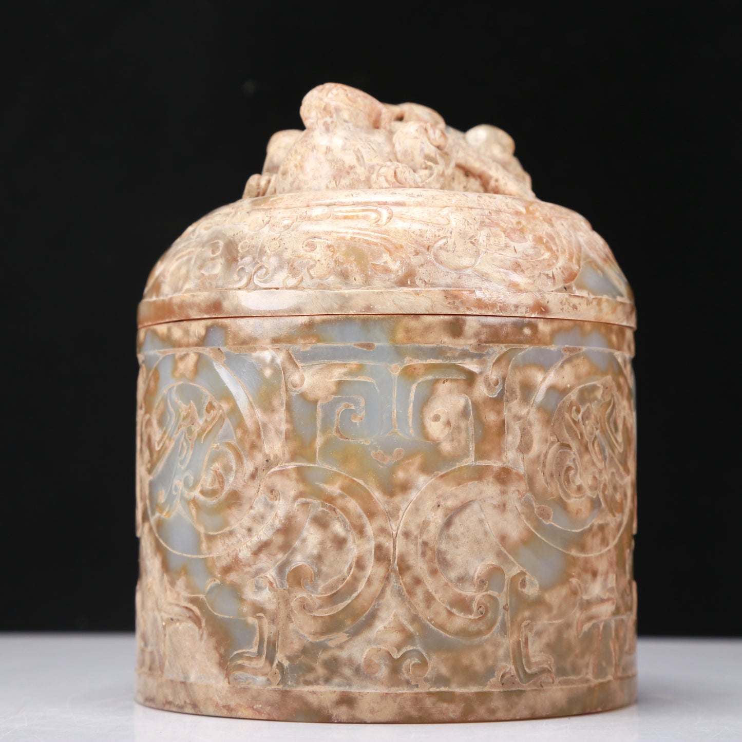 An Archaic White Jade 'Auspicious Beast' Jar And Cover