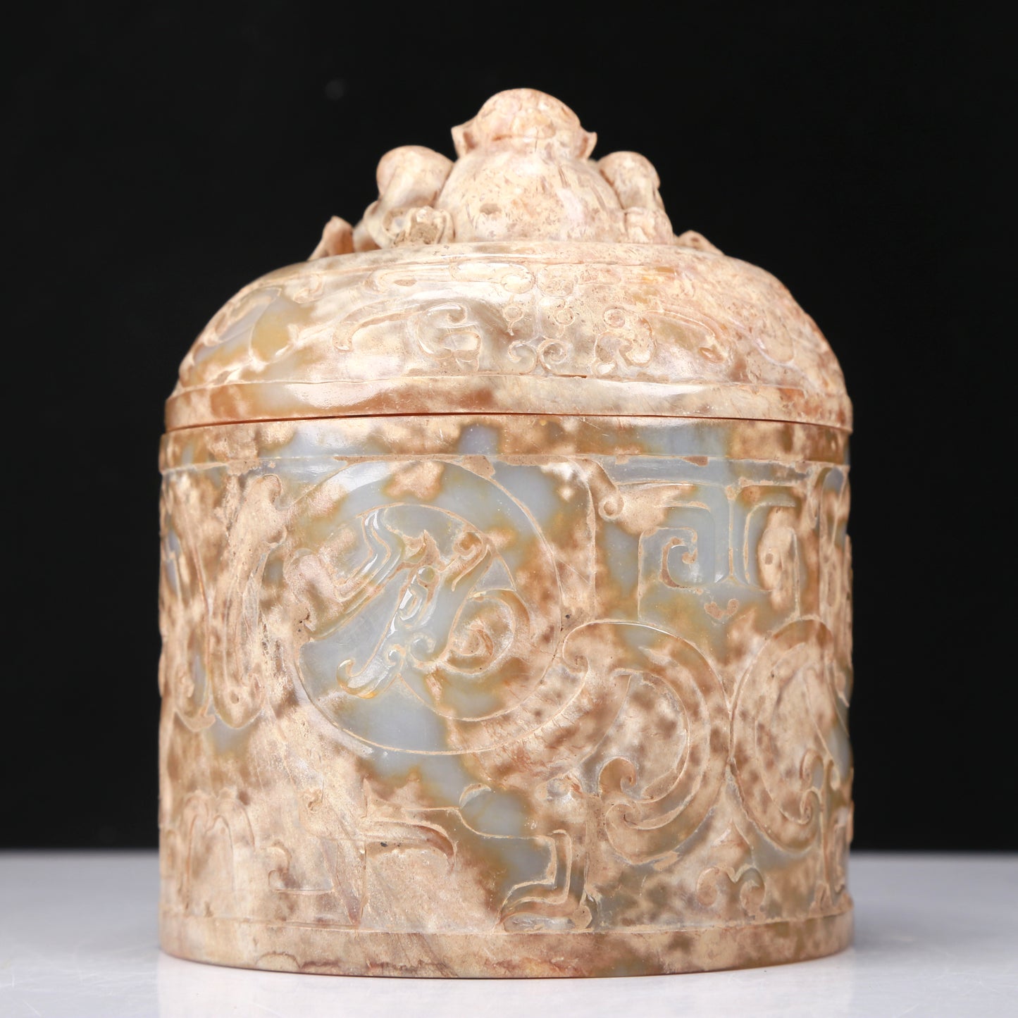 An Archaic White Jade 'Auspicious Beast' Jar And Cover