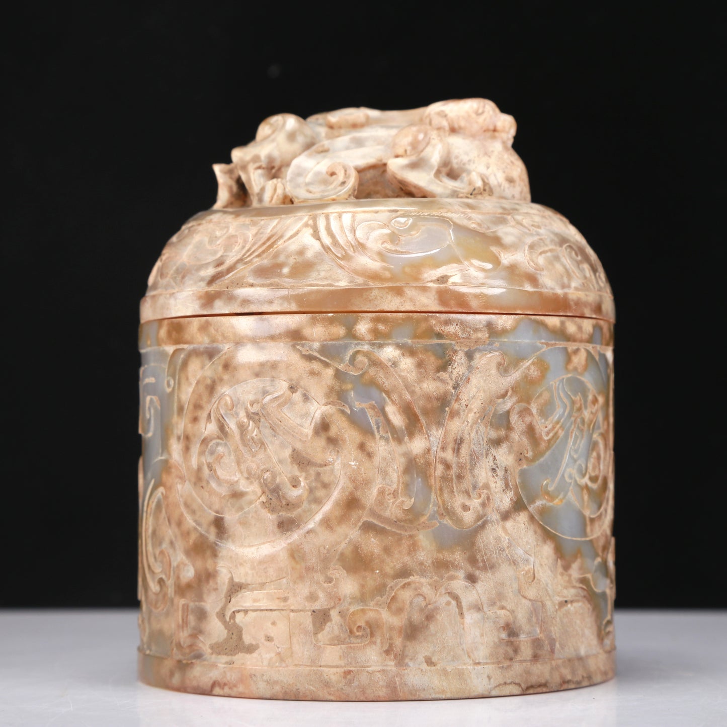 An Archaic White Jade 'Auspicious Beast' Jar And Cover