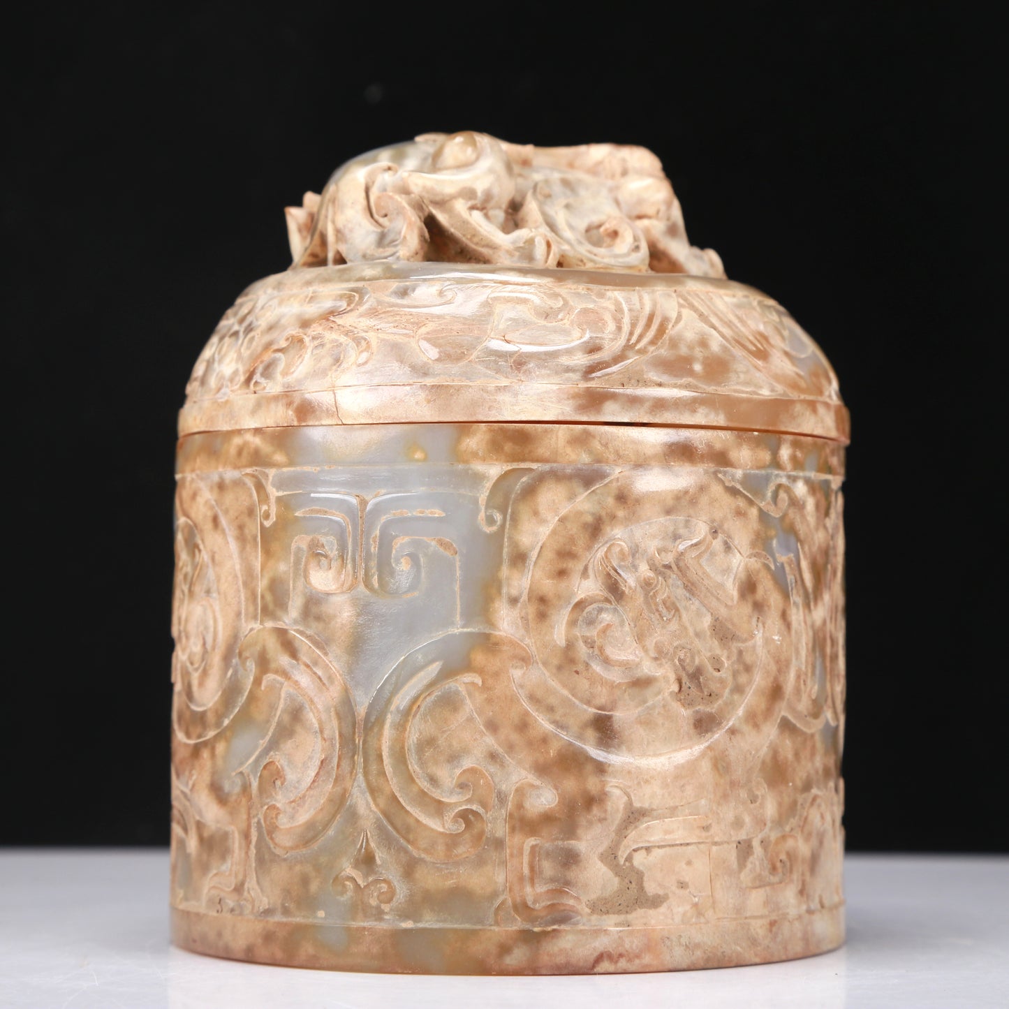 An Archaic White Jade 'Auspicious Beast' Jar And Cover