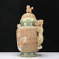 An Archaic Celadon-White Jade 'Animal Mask' Dragon-Handled Vase And Cover