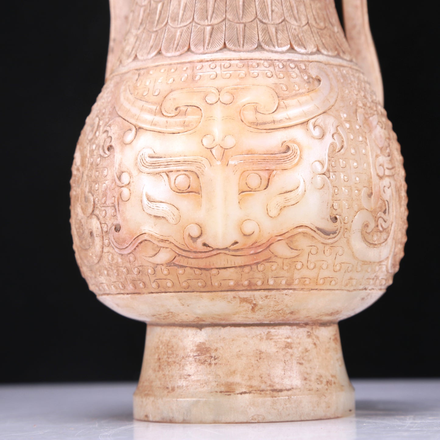 An Archaic White Jade 'Animal Mask' Vase With An Overhead Handle