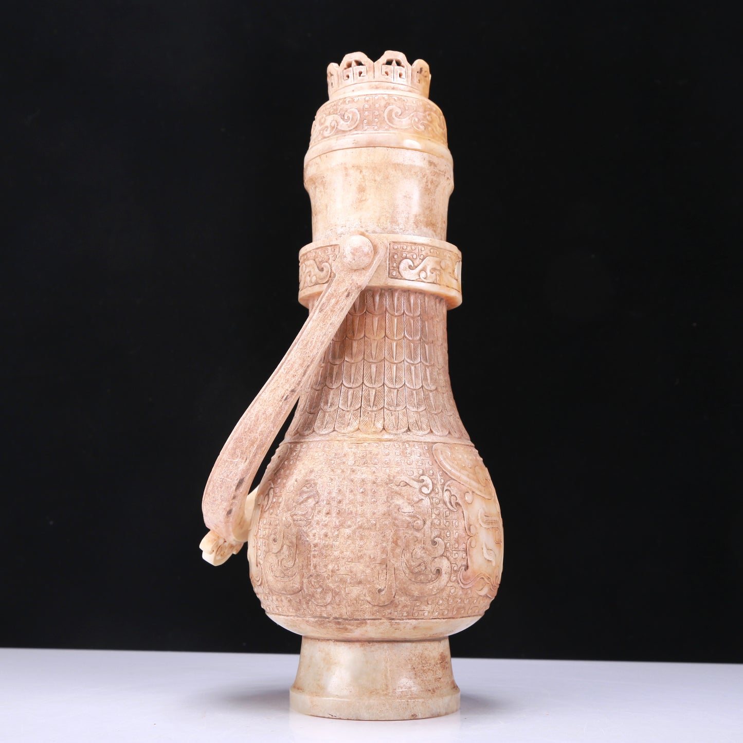 An Archaic White Jade 'Animal Mask' Vase With An Overhead Handle