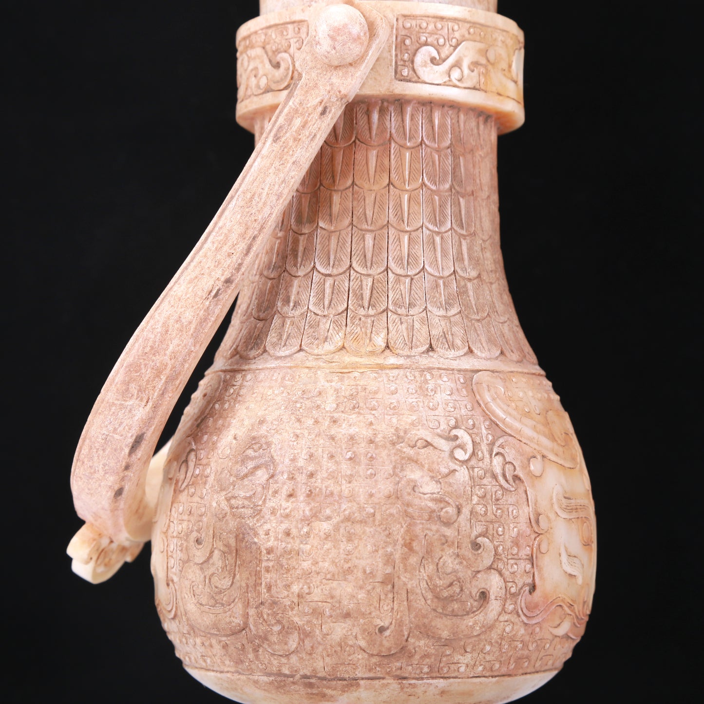 An Archaic White Jade 'Animal Mask' Vase With An Overhead Handle