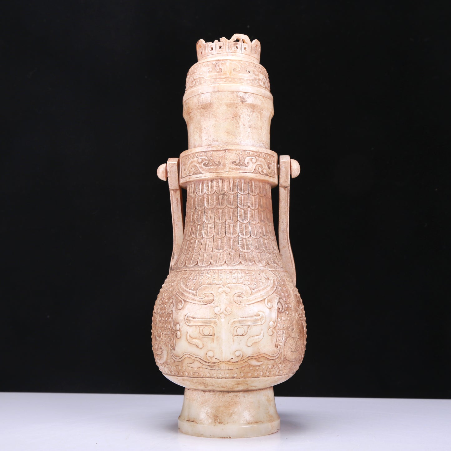 An Archaic White Jade 'Animal Mask' Vase With An Overhead Handle