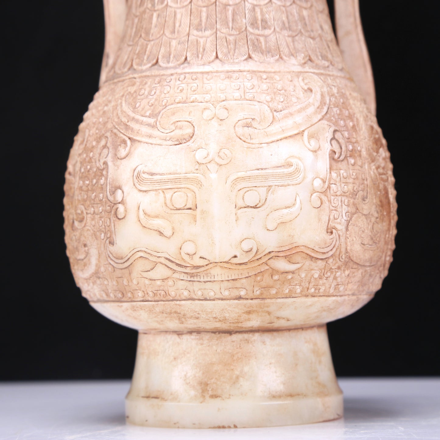 An Archaic White Jade 'Animal Mask' Vase With An Overhead Handle