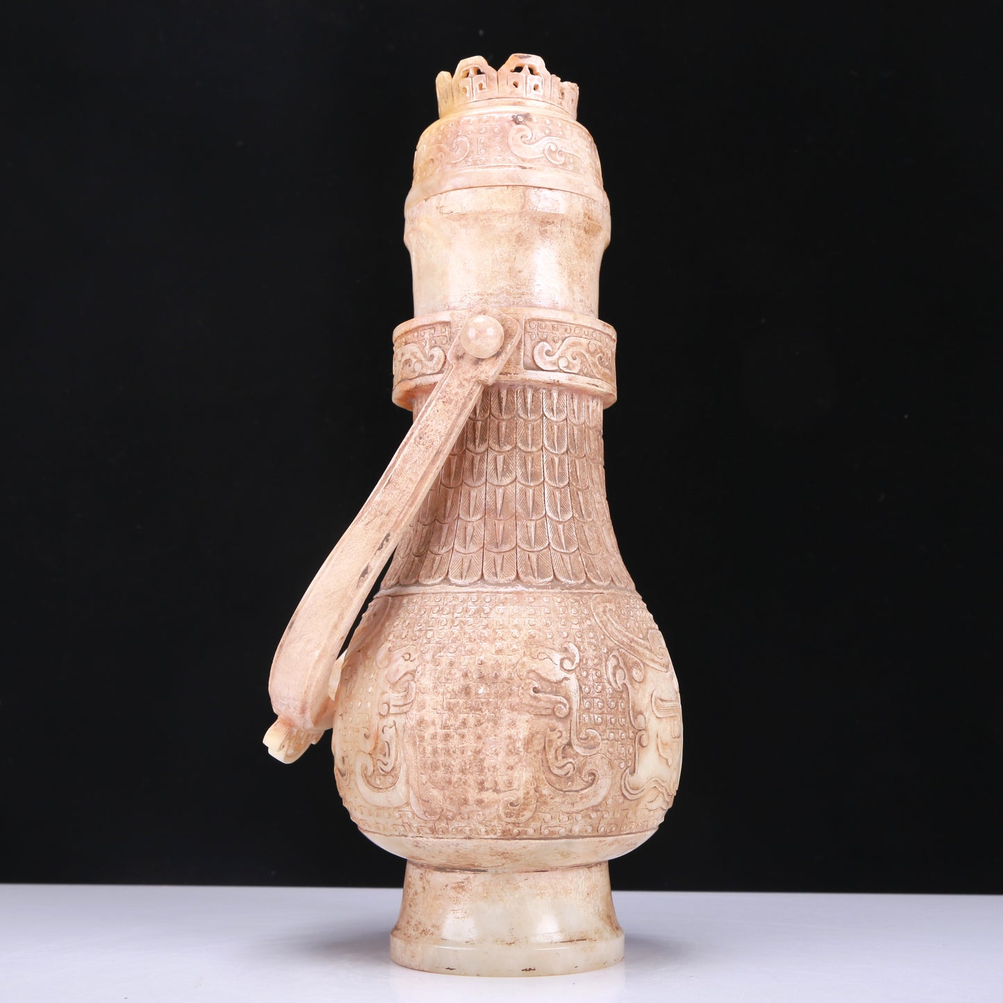 An Archaic White Jade 'Animal Mask' Vase With An Overhead Handle