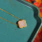 Gilt silver inlaid Hetian jade four-leaf clover pendant